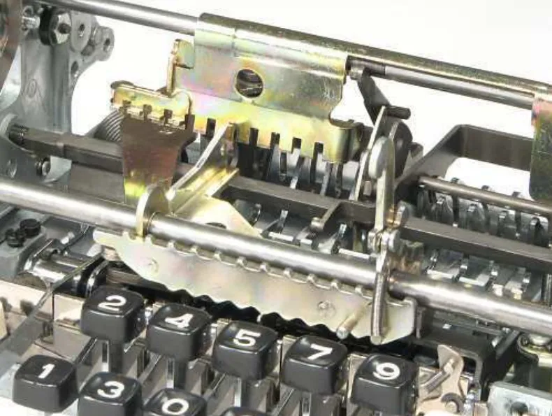 Both parts installed in the calculator's multiplication mechanism